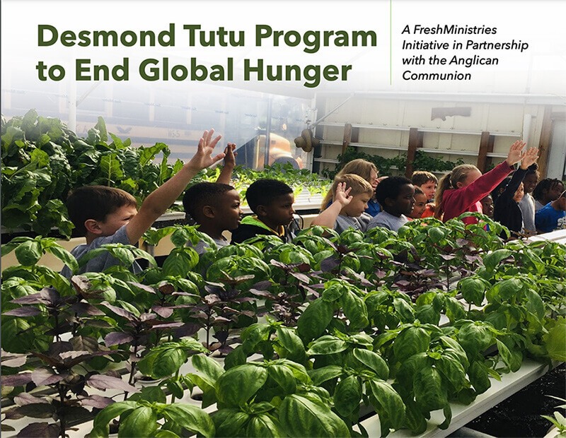 Children raising hands with rows of plants around them
